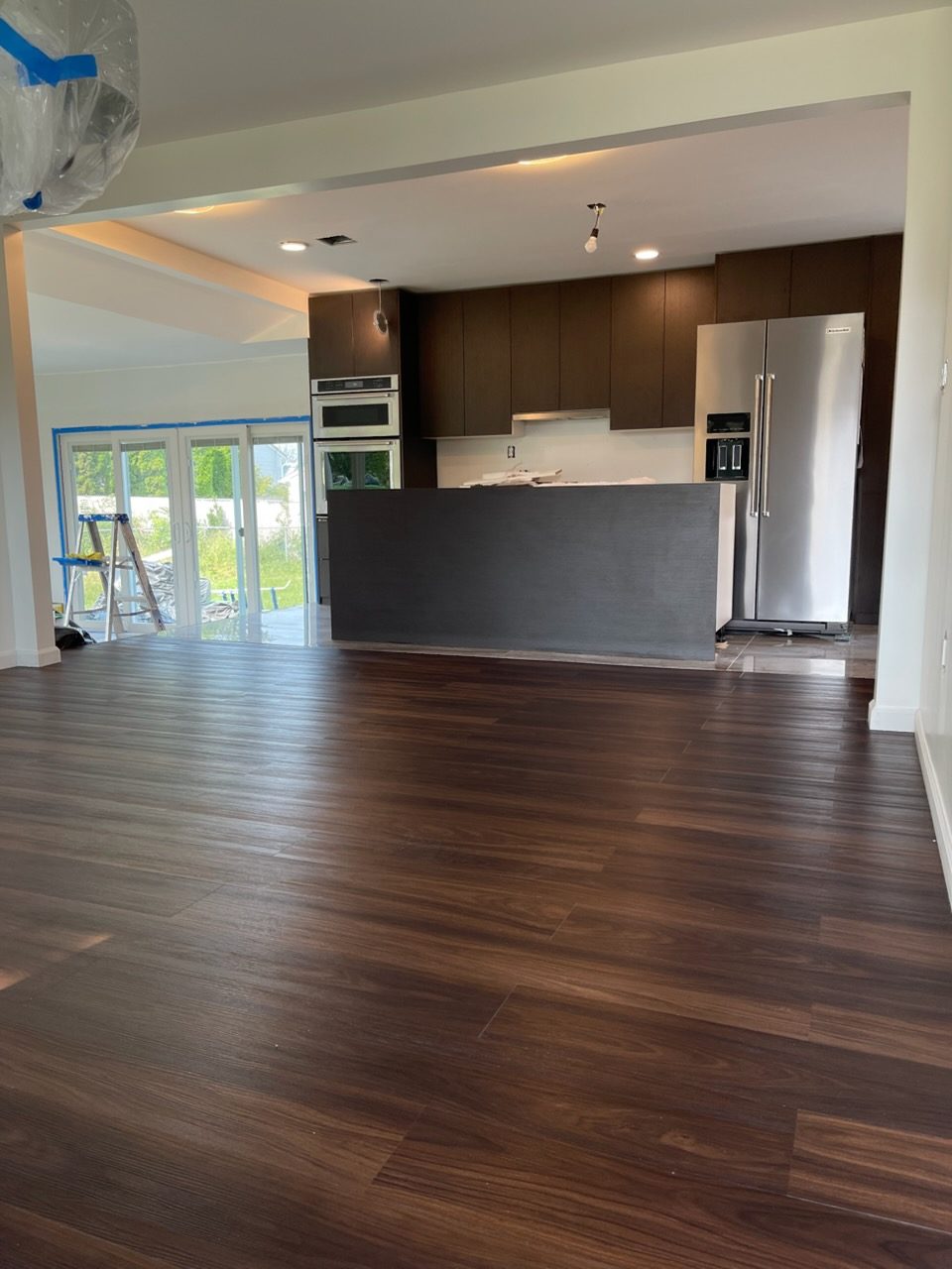 After: the same open kitchen and floor, cleaned move-in ready