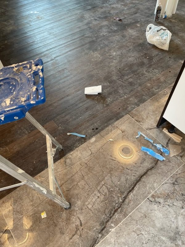 Before: post-construction floor, dust, debris and tape