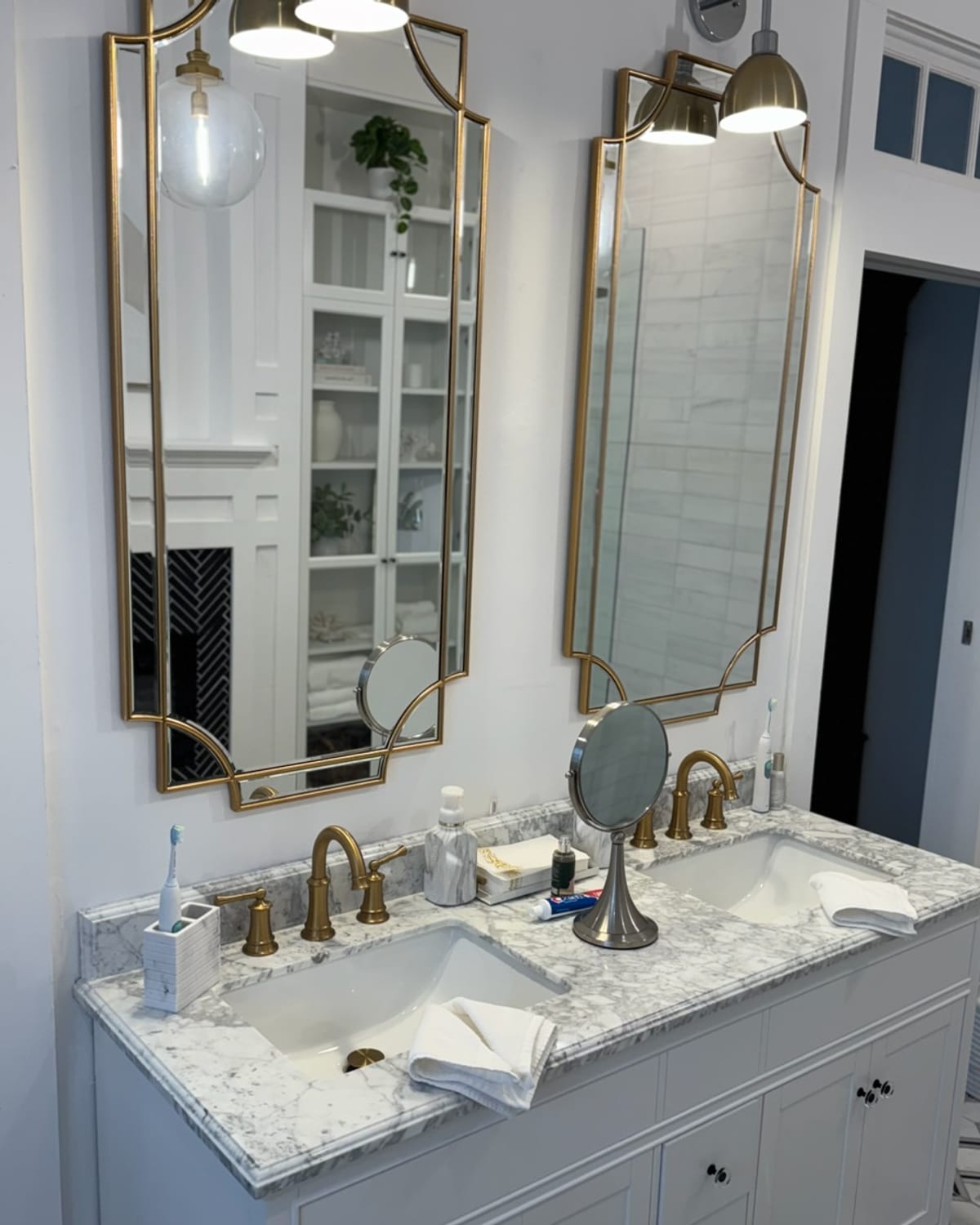 Marble double vanity with gold mirrors, detailed spotless