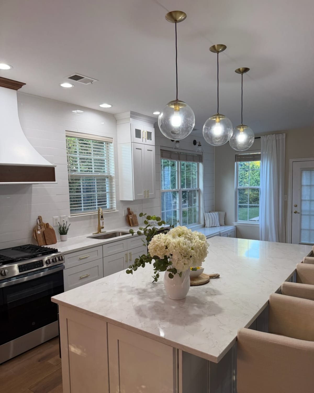 White quartz-island kitchen, mirror-finish clean