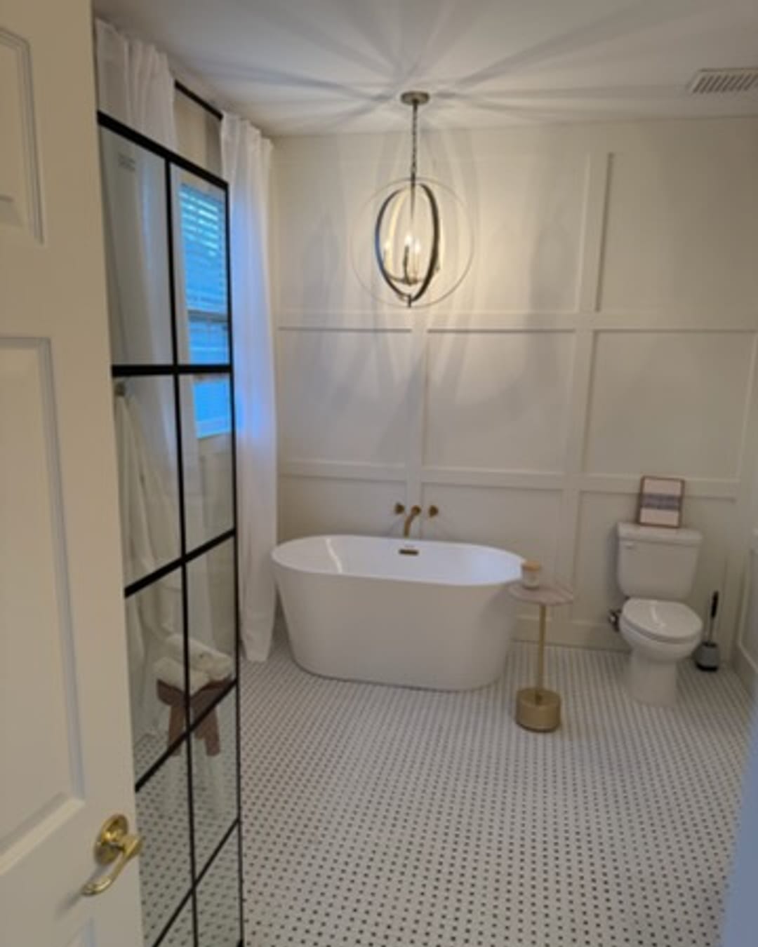 Freestanding tub under a chandelier, reset to new