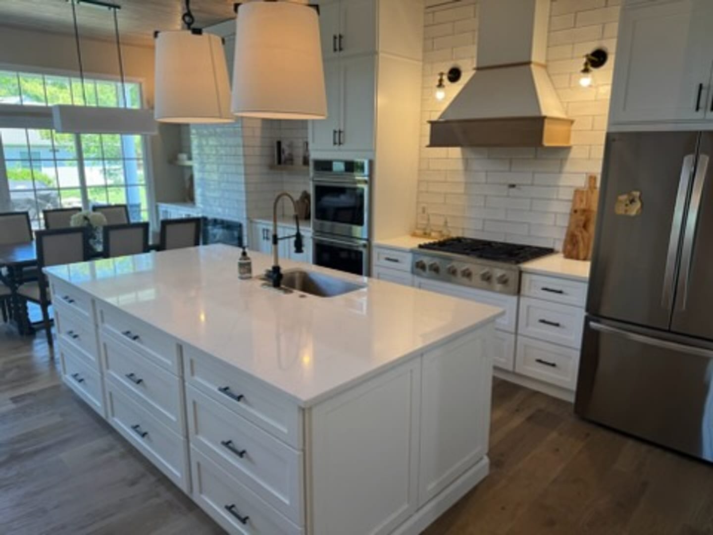White island kitchen with wood range hood, detailed